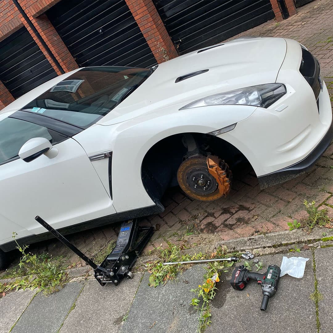   Fast Tyre service at night with technician changing tyre