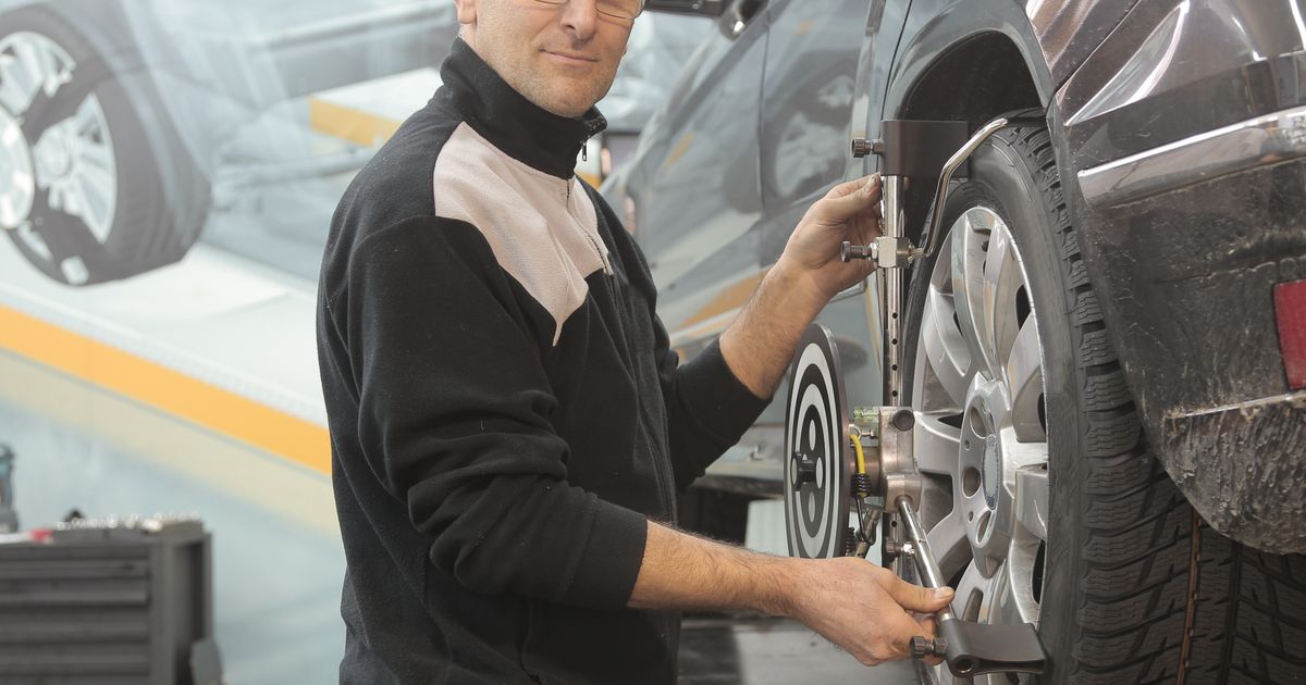 Technician fitting a budget car tyre during a mobile visit