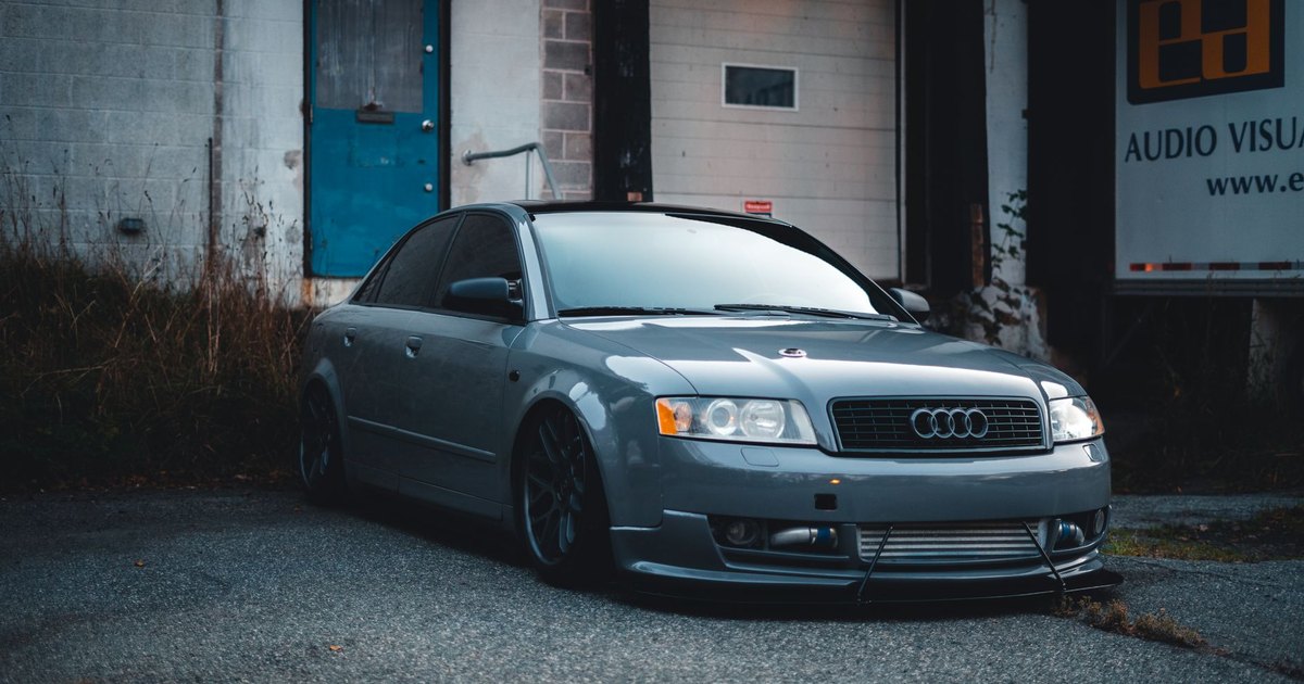 Grey Audi saloon parked on an urban street, showing its wheels and stance