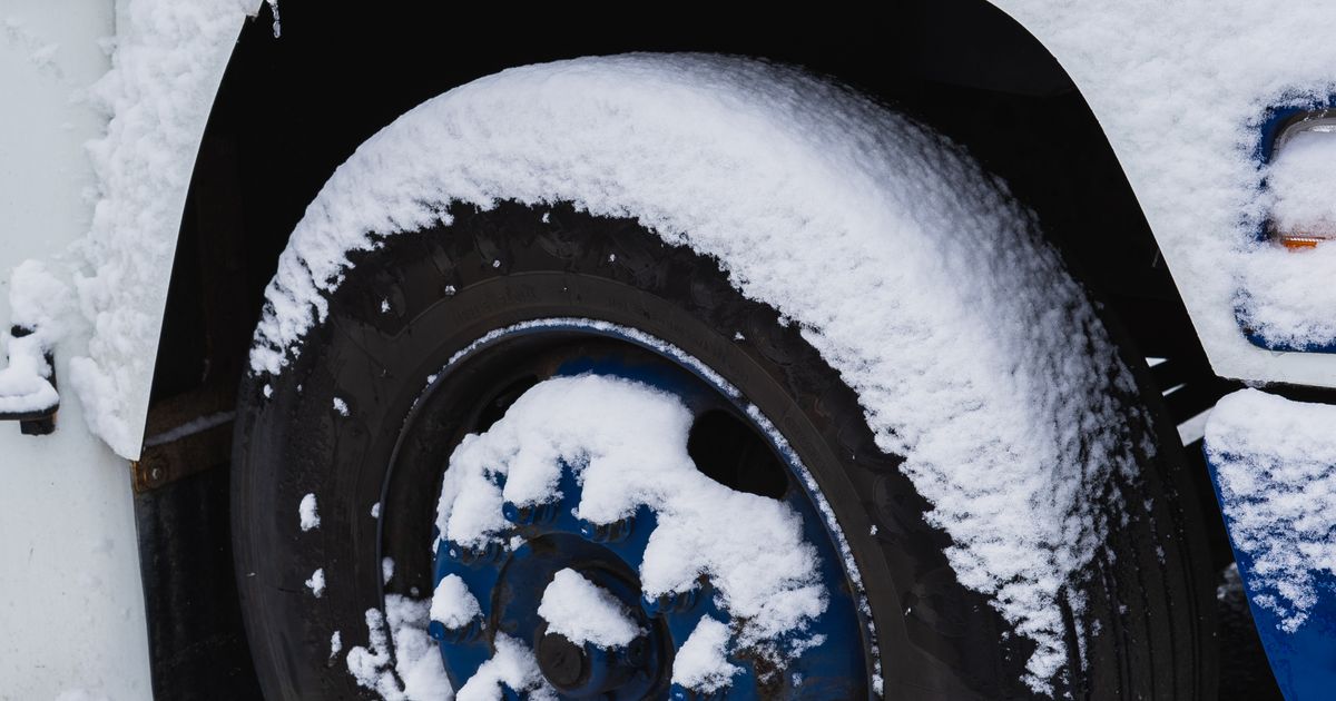 Car fitted with winter tyres driving on a cold, frosty British road