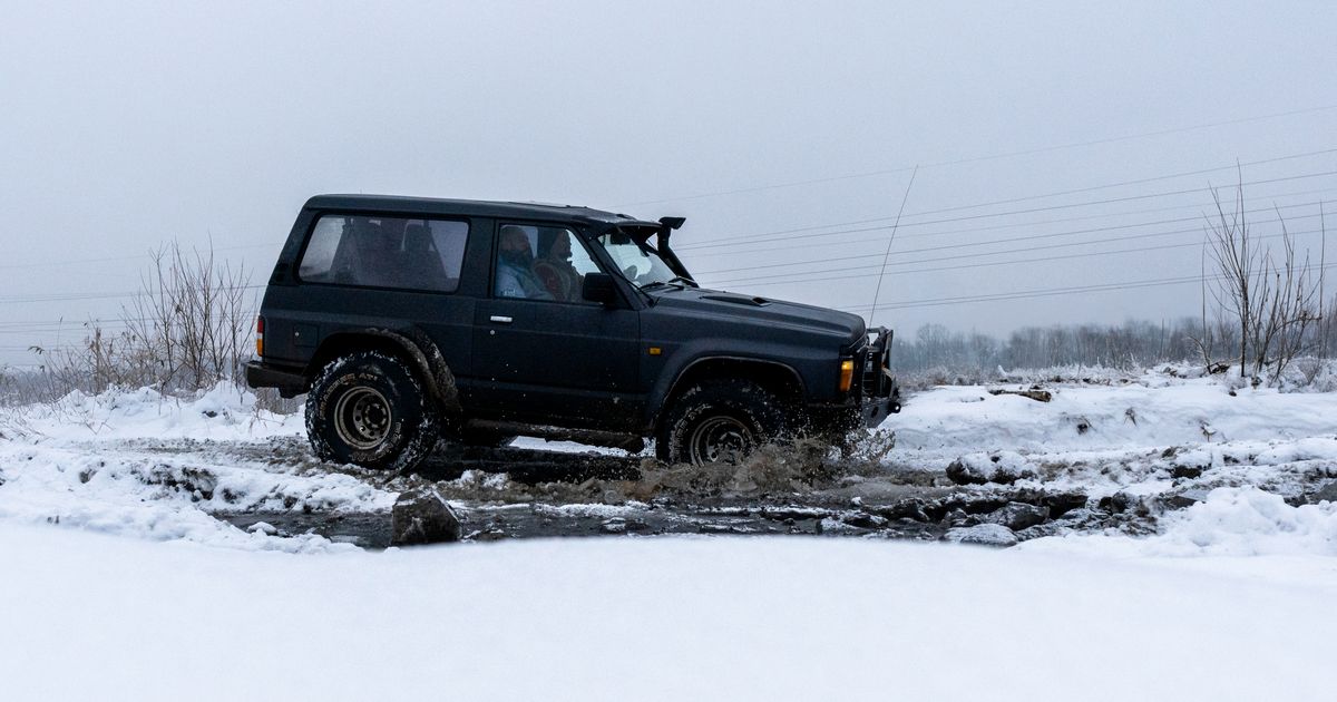 Car tyre gripping a snow-covered road in winter driving conditions