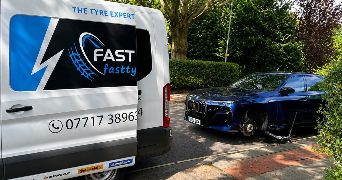Fast Tyre van alongside a car with its wheel removed on a driveway