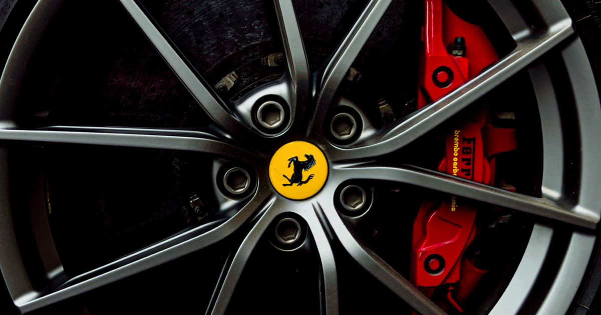 Car alloy wheel with a kerbed, scuffed rim and a scraped tyre sidewall after hitting a kerb