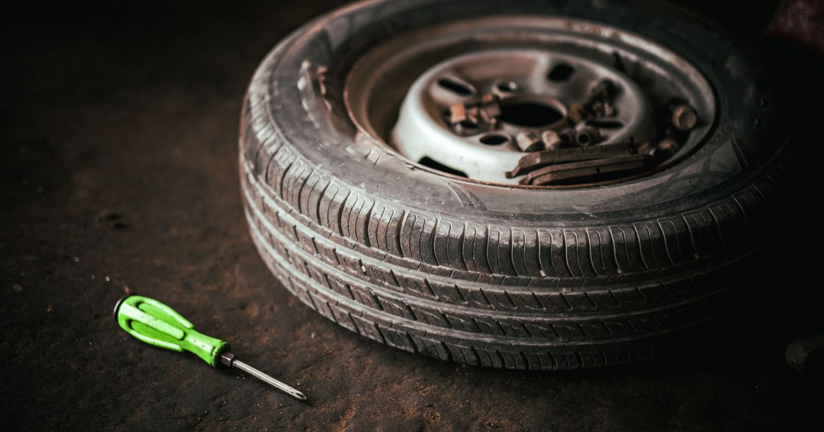 A nail embedded in the tread of a car tyre