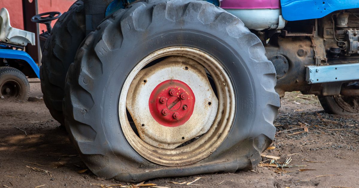Technician inspecting a tyre for a slow puncture during a mobile repair
