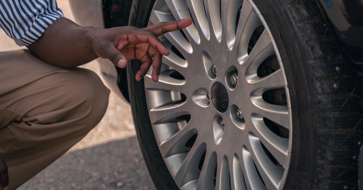 Space-saver spare wheel fitted to a car at the roadside