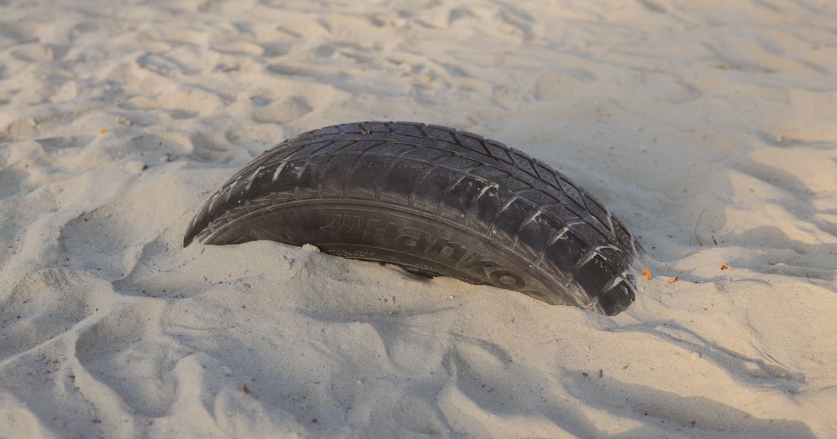 Close-up of a damaged tyre sidewall showing a bulge and cut