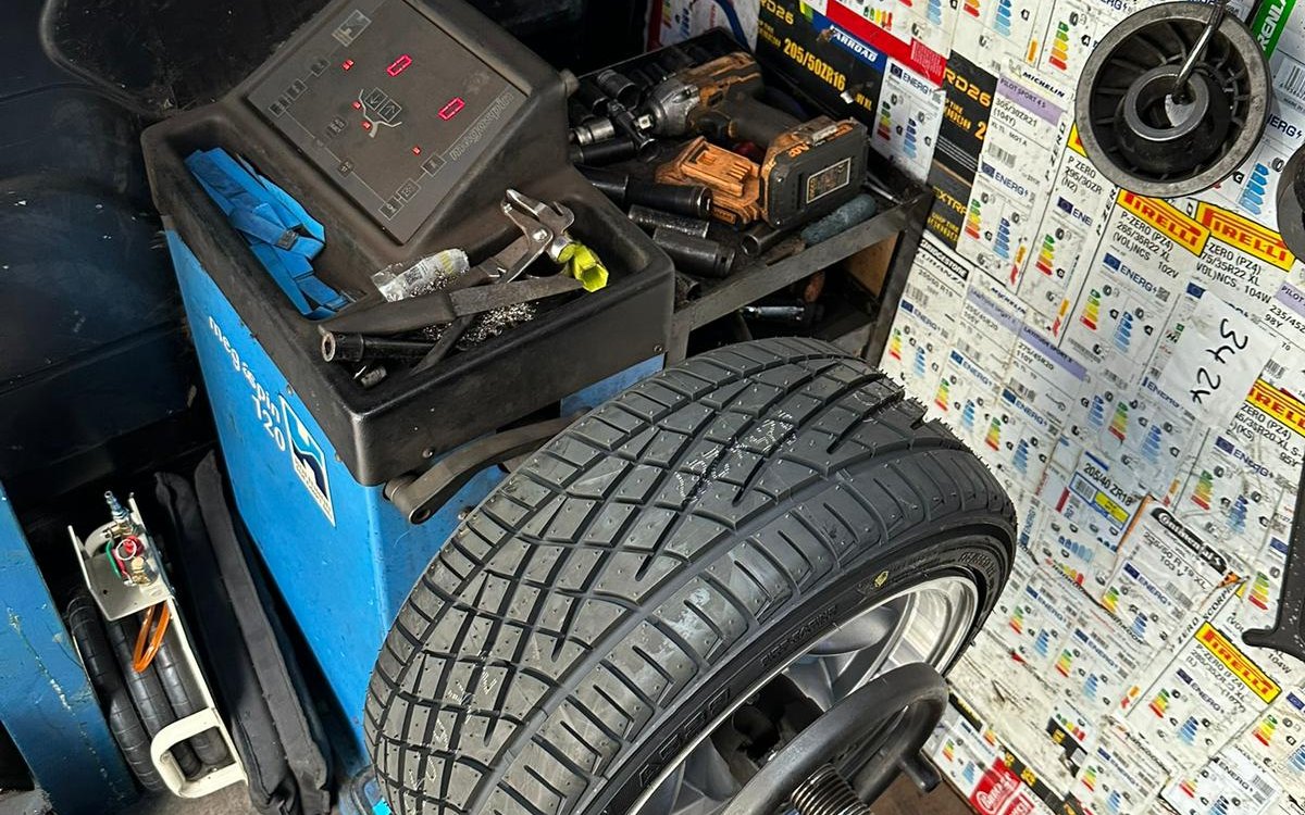 A wheel mounted on the balancer inside a Fast Tyre van