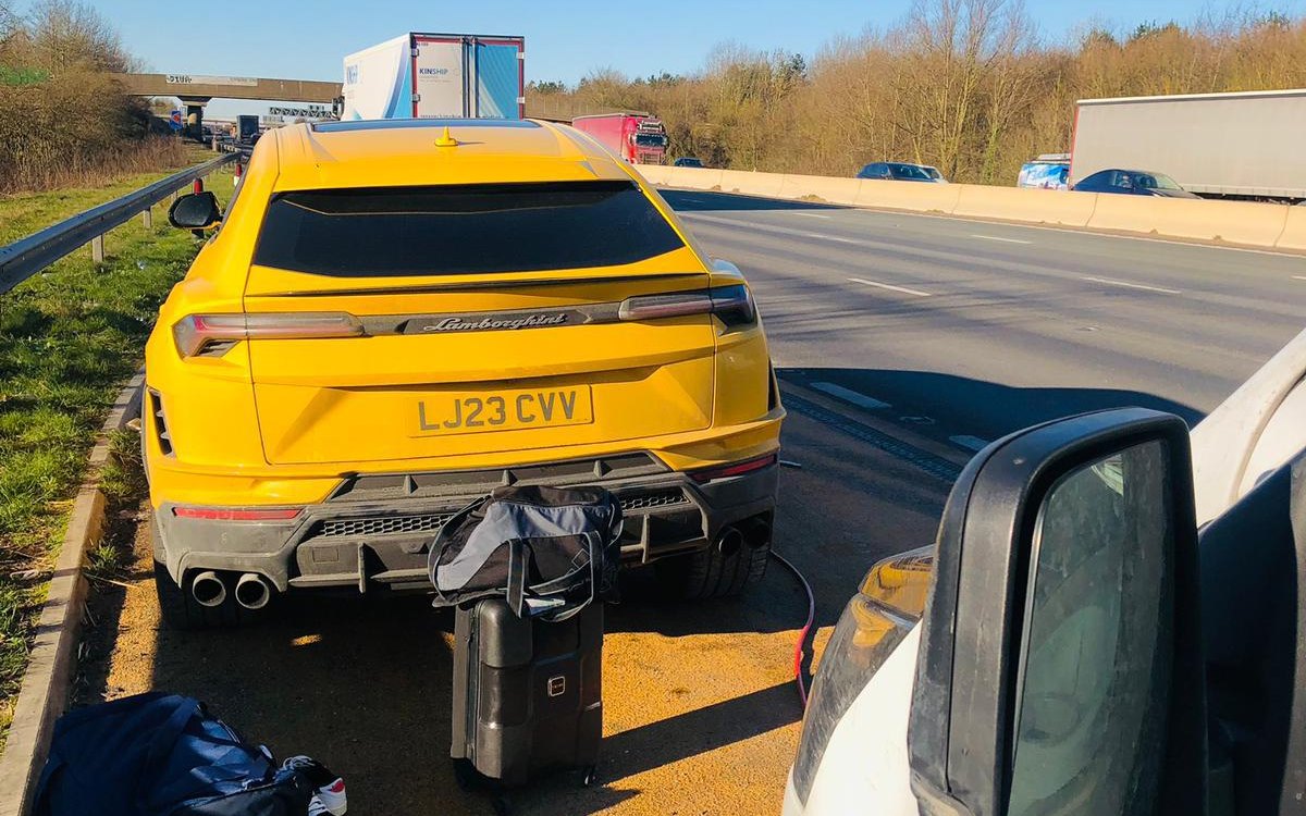 A yellow Lamborghini on the hard shoulder, seen from inside the Fast Tyre van, serving Barnes, Greater London