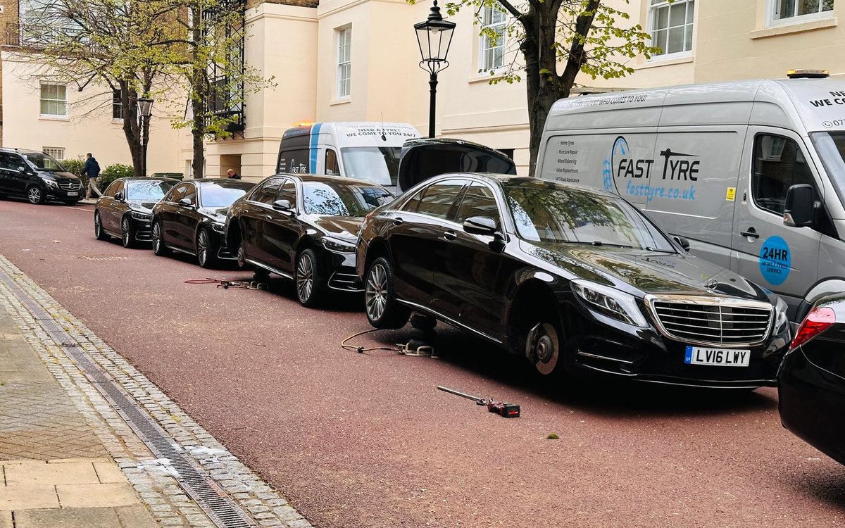 A Fast Tyre van working along a row of parked cars on a Georgian terrace
