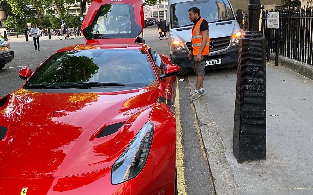 A red Ferrari on a London street with the Fast Tyre van and engineer alongside, serving Henlow, Bedfordshire